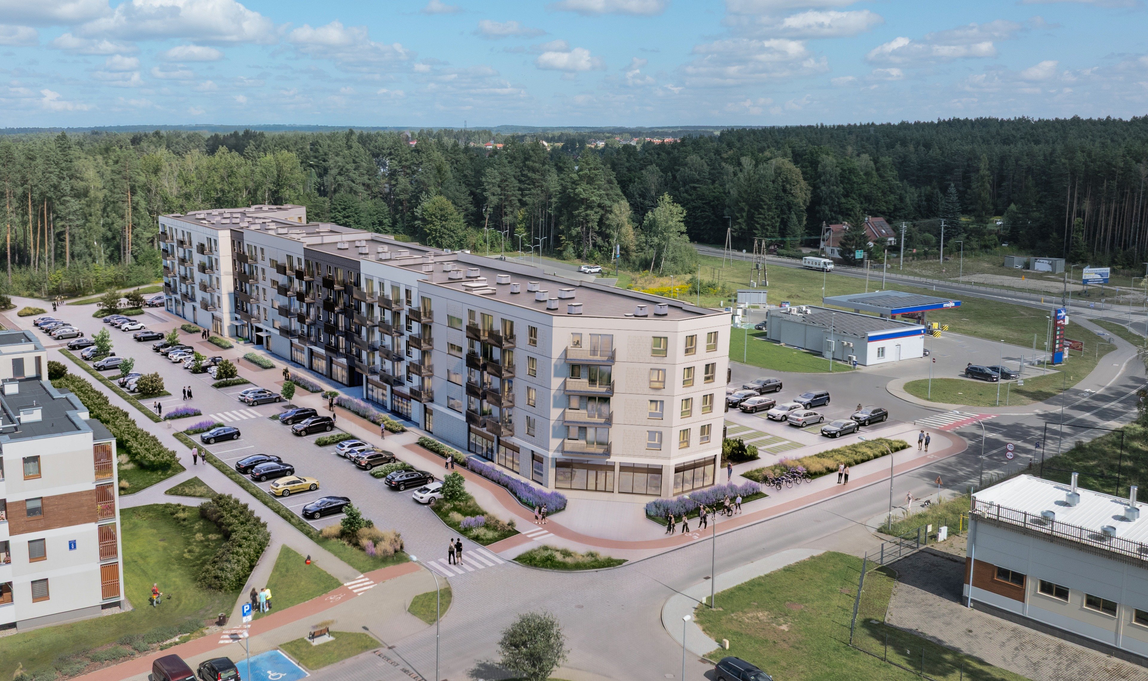 Budynek S19 z lotu ptaka, na pierwszym planie parter z lokalami usługowymi, wokół las